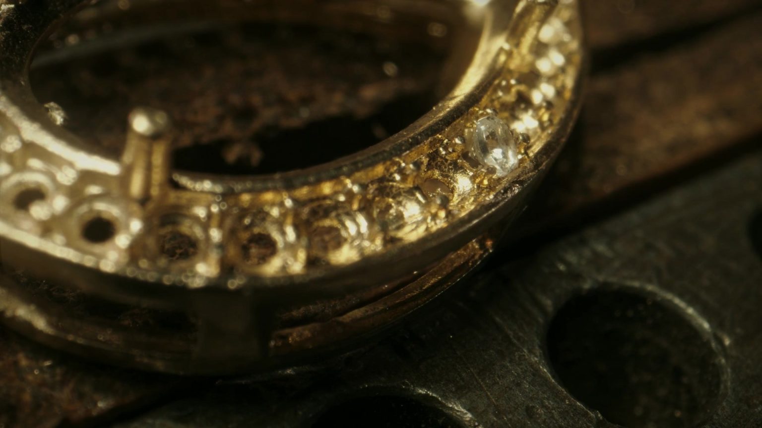Diamonds being set by hand into a gold ring